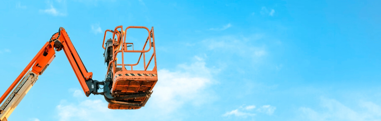 Cherry picker against blue sky