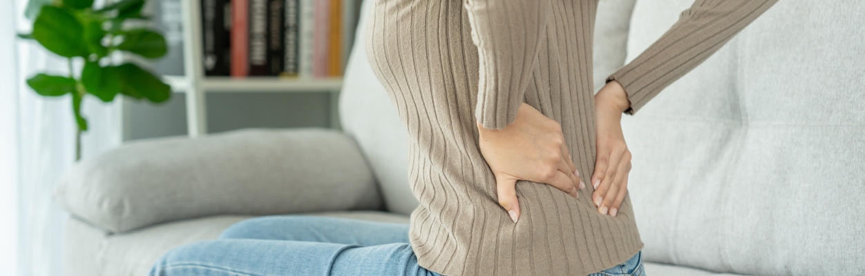 Woman holding painful back